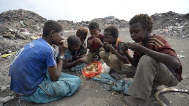Boys eat at a rubbish dump where they are collecting recyclable waste outside Yemen's Red Sea port city of Houdieda January 20, 2016. REUTERS/Abduljabbar Zeyad TPX IMAGES OF THE DAY