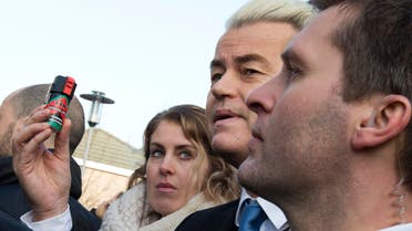 Firebrand Dutch lawmaker Geert Wilders holds a can of pepper spray prior to handing out self-defense sprays to women fearful of being attacked by migrants (AP)
