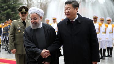Chinese President Xi Jinping, right, shakes hands with Iranian President Hassan Rouhani in an official arrival ceremony, at the Saadabad Palace in Tehran, Iran, Saturday, Jan. 23, 2016. (AP