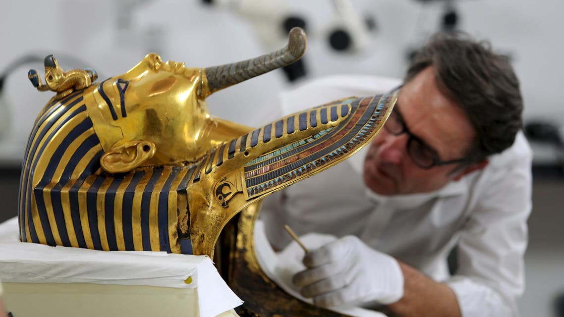 German conservator Christian Eckmann works on the restoration of the golden mask of King Tutankhamun at the Egyptian Museum in Cairo, Egypt, October 20, 2015. REUTERS
