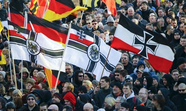 Supporters of anti-immigration right-wing movement PEGIDA (Patriotic Europeans Against the Islamisation of the West) carry various versions of the Imperial War Flag (Reichskriegsflagge) during a demonstration march, in reaction to mass assaults on women on New Year's Eve, in Cologne, Germany January 9, 2016. reuters