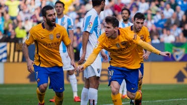 FC Barcelona's Lionel Messi, right, reacts next to teammate Arda Turan after scoring against Malaga during a Spanish La Liga soccer match between Malaga and FC Barcelona at La Rosaleda stadium in Malaga, Spain, Saturday, Jan. 23, 2016 (AP)