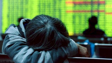 File photo of an investor resting in front of an electronic screen showing stock information at brokerage house in Hangzhou. (Reuters)