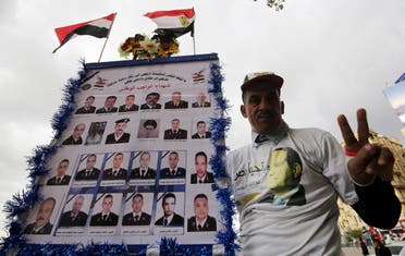 A pro-government protester chants slogans while holding a poster with pictures of martyrs police and army during the fifth anniversary of the uprising that ended the 30-year reign of Hosni Mubarak in Cairo, Egypt, January 25, 2016. REU