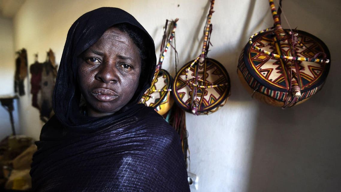 A Tuareg woman who is an imzad instrument maker poses for a picture at the "Home of the Imzad" in Tamanrasset in Southern Algeria. (AFP)