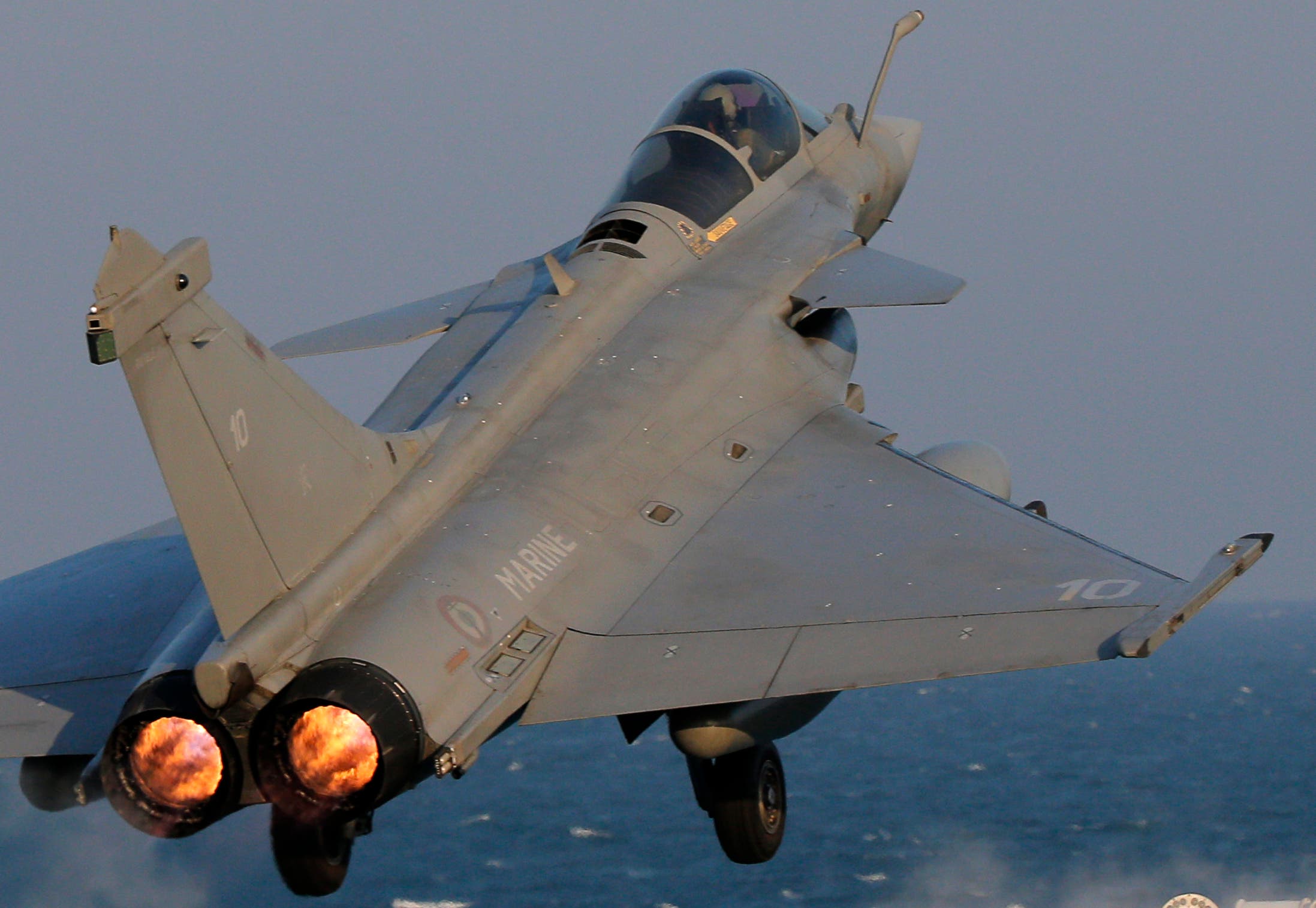 A Rafale fighter jet is catapulted for a mission, on France's flagship Charles de Gaulle aircraft carrier in the Persian Gulf, Wednesday, Jan. 13, 2016. The Charles de Gaulle joined the U.S.- led coalition against Islamic State group in November, as France intensified its airstrikes against extremist sites in Syria and Iraq in response to Islamic State group threats against French targets. (AP Photo/Christophe Ena)