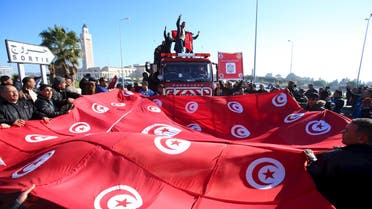 Tunisian police officers and security personnel shout slogans and hold flags during a protest in Tunis. (Reuters)