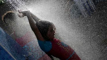 A holiday-maker takes a shower at a beach in Suez, 127 kilometers (79 miles) east of Cairo, Egypt, Sunday, Aug. 9, 2015. Sunday’s temperature reached 39 ?C (102 F) in Cairo and 45 ?C in the Upper Egypt governorates. (File photo: AP)
