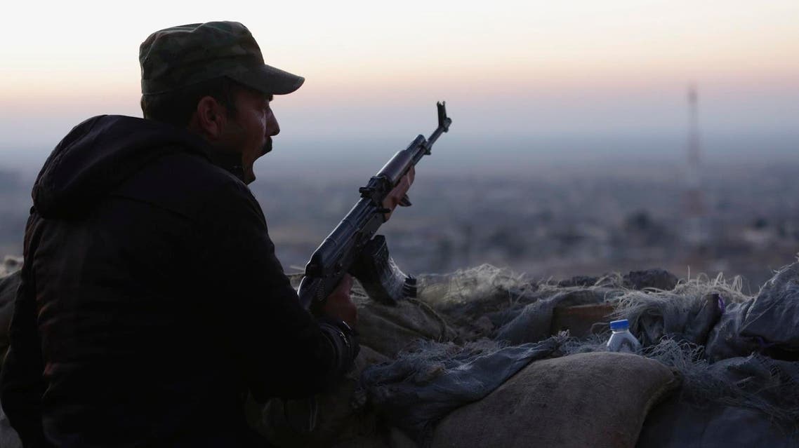 A peshmerga, yawns as he stands guard on the frontline in Sinjar, Iraq. (AP)