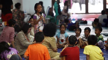    BAY1755 - JAKARTA, -, INDONESIA : In this photo taken on January 26, 2016, children of members of the Light of Nusantara Movement (Gafatar), who were relocated from their village in Borneo following a mob attack, play and learn at a shelter in Jakarta. Indonesia has relocated more than 1,500 members of a controversial sect from their village "for their own safety", an official said January 27, but rights groups described their treatment as religious persecution. AFP PHOTO / Muhammad RASYA
