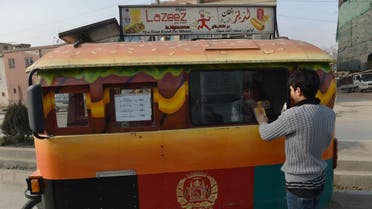 an Afghan customer buys a burger from a Lazeez food truck in Kabul. (AFP)