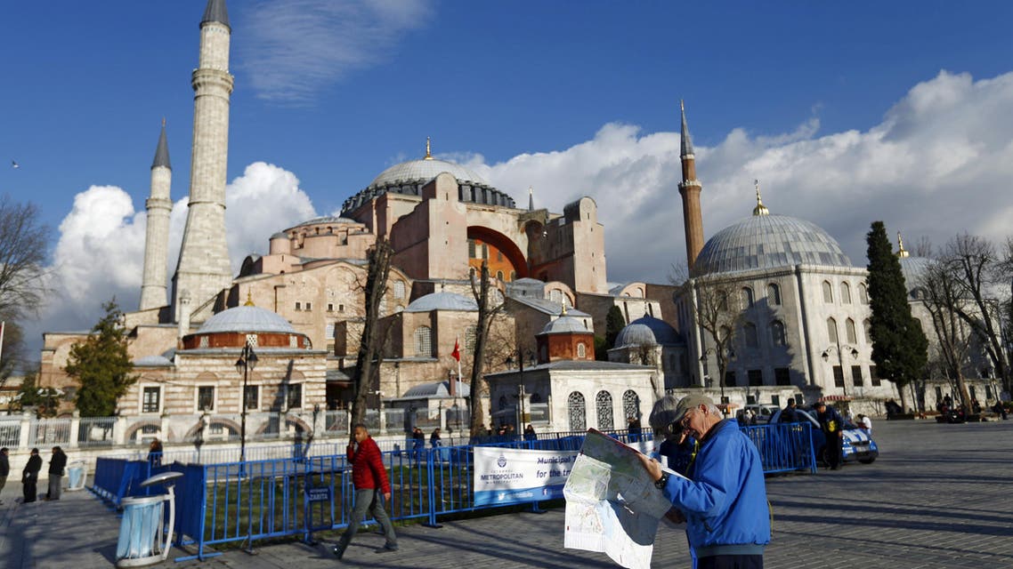 A tourist couple checks a map, near the Byzantine-era monument of Hagia Sophia, at Sultanahmet square in Istanbul,Turkey January 14, 2016. (Reuters)