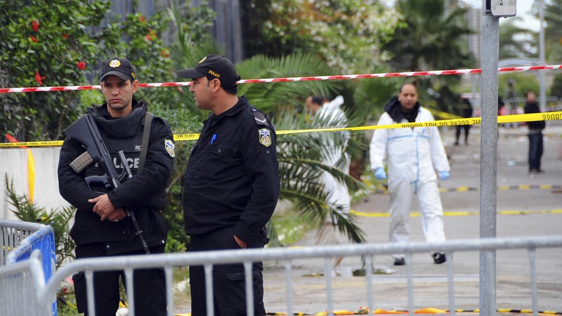 Police officers secure the area where a bus exploded Tuesday in Tunis, Wednesday Nov.25, 2015. Tunisia's Interior Ministry says 10 kilograms (22 pounds) of military explosives were used in an attack on a bus carrying presidential guards that left at least 13 people dead. (AP Photo)