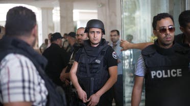  Tunisian police officers stay in the lobby of an hotel where a terrorist attack took place in the coastal town of Sousse, Tunisia, Friday June 26, 2015. A young man unfurled an umbrella and pulled out a Kalashnikov, opening fire on European sunbathers in an attack that killed at least 28 people at a Tunisian beach resort — one of three deadly attacks from Europe to the Middle East on Friday that followed a call to violence by Islamic State extremists. (AP Photo/Leila Khemissi)