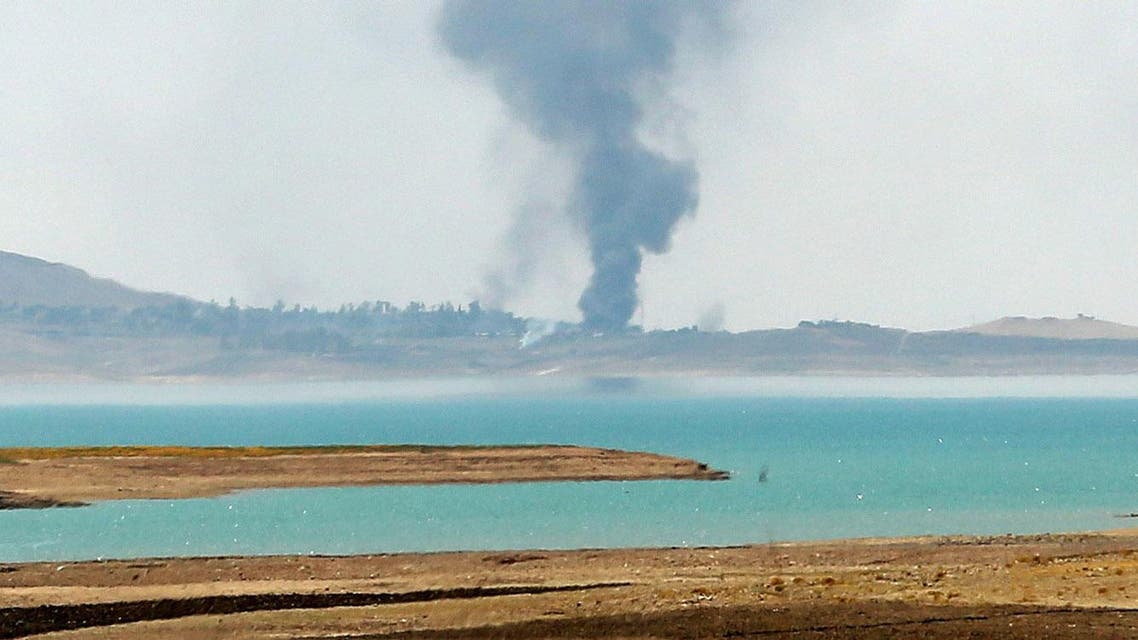 Smoke rises during airstrikes targeting Islamic State militants at the Mosul Dam outside Mosul, Iraq, Monday, Aug. 18, 2014. Boosted by two days of U.S. airstrikes, Iraqi and Kurdish forces on Monday wrested back control of the country's largest dam from Islamic militants, a military spokesman in Baghdad said, as fighting was reported to be underway for the rest of the strategic facility. (AP Photo/Khalid Mohammed)