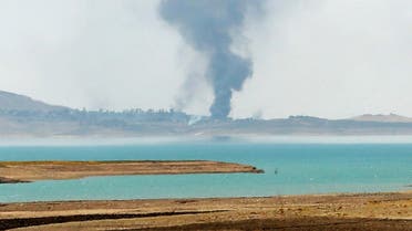  Smoke rises during airstrikes targeting Islamic State militants at the Mosul Dam outside Mosul, Iraq, Monday, Aug. 18, 2014. Boosted by two days of U.S. airstrikes, Iraqi and Kurdish forces on Monday wrested back control of the country's largest dam from Islamic militants, a military spokesman in Baghdad said, as fighting was reported to be underway for the rest of the strategic facility. (AP Photo/Khalid Mohammed)