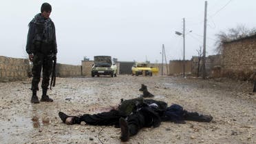  Free Syrian Army fighter inspects a dead Islamic State fighter after they took control of the area in the northern Aleppo countryside, Syria, January 18, 2016. (Reuters)