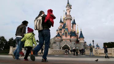 File picture shows visitors walking towards the Sleeping Beauty Castle during a visit to the Disneyland Paris Resort run by EuroDisney S.C.A in Marne-la-Vallee January 21, 2015. REUTERS/Gonzalo Fuentes/Files