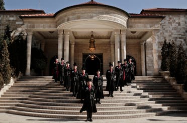 In this Monday, Jan. 11, 2016 photo, Circassian guards pose for a photograph in front of Basman Palace, in Amman, Jordan. Chosen from the various Circassian tribes in Jordan, recruits undergo eight months of training in self-defense, security, palace protocol, and military techniques.(AP