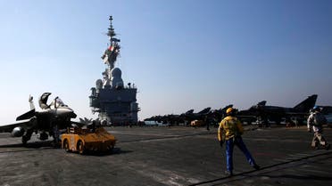 A Rafale fighter jet is parked after a mission on France's flagship Charles de Gaulle aircraft carrier in the Persian Gulf, Wednesday, Jan. 13, 2016. The Charles de Gaulle joined the U.S.- led coalition against Islamic State group in November, as France intensified its airstrikes against extremist sites in Syria and Iraq in response to Islamic State group threats against French targets. (AP Photo/Christophe Ena)