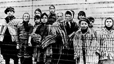 A picture taken just after the liberation by the Soviet army in January, 1945, shows a group of children wearing concentration camp uniforms behind barbed wire fencing in the Auschwitz Nazi concentration camp. On Thursday Jan. 22, 2015, Russia accused Poland of engaging in a “mockery of history” after the Polish foreign minister Grzegorz Schetyna credited Ukrainian soldiers, rather than the Soviet Red Army, with liberating Auschwitz 70-years ago. The latest exchange comes prior to the 70th anniversary of the liberation of Auschwitz by Soviet troops on Jan. 27, 1945, underlining deep tensions between Russia and Poland, which is hugely critical of Russia's recent actions in Ukraine. (AP Photo/FILE)