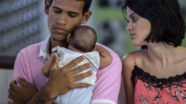 Matheus Lima,22, and Kleisse Marcelina,24, tend their two-month-old son Pietro suffering from microcephalia caught through an Aedes aegypti mosquito bite, at the Obras Sociais Irma Dulce hospital in Salvador, Brazil on January 27, 2016. AFP PHOTO / Christophe SIMON / AFP / CHRISTOPHE SIMON