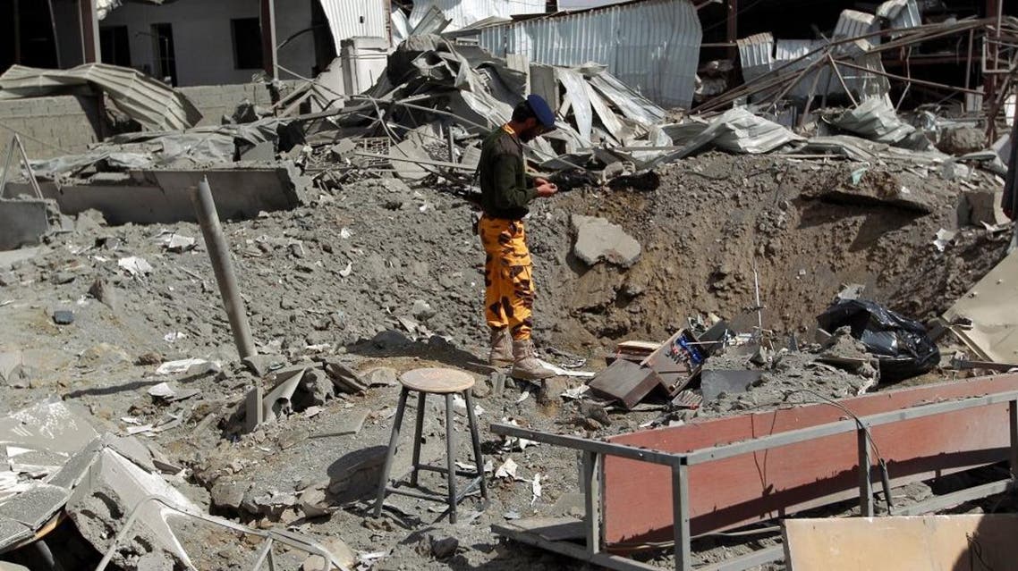 A Yemeni security member inspects the damage at the Queen Arwa University campus following a Saudi-led airstrike in the capital Sanaa, on January 30, 2016. / AFP / MOHAMMED HUWAIS