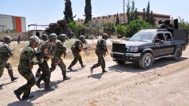 In this file photo released on Sunday, May 26, 2013, by the Syrian official news agency SANA, Syrian forces loyal to Syrian President Bashar Assad take their position during clashes against Syrian rebels, in Aleppo, Syria.
