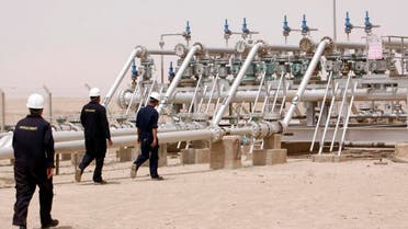 Oil industry workers are seen at a newly inaugurated gas processing facility at Tuba oil field in the southern oil-rich province of Basra, 550 kilometers (340 miles) southeast of Baghdad, Iraq, Saturday, June 4, 2011. Wasfi Tahir Bashit, who oversees production at the field, said the facility will process 20,000 barrels of crude oil a day. It will help capturing 30 million cubic feet of associated natural gas which was being wasted due to lack of infrastructure, Bashit said.(AP Photo/ Nabil al-Jurani)