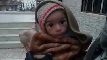 A toddler is held up to the camera in this still image taken from video said to be shot in Madaya on January 5, 2016. Warnings of widespread starvation are growing as pro-government forces besiege an opposition-held town in Syria and winter bites, darkening the already bleak outlook for peace talks the United Nations hopes to convene this month. To match MIDEAST-CRISIS/SYRIA-TOWN Handout via Social Media Website ATTENTION EDITORS - THIS PICTURE WAS PROVIDED BY A THIRD PARTY. REUTERS IS UNABLE TO INDEPENDENTLY VERIFY THE AUTHENTICITY, CONTENT, LOCATION OR DATE OF THIS IMAGE. FOR EDITORIAL USE ONLY. NOT FOR SALE FOR MARKETING OR ADVERTISING CAMPAIGNS. THIS PICTURE IS DISTRIBUTED EXACTLY AS RECEIVED BY REUTERS, AS A SERVICE TO CLIENTS. EDITORIAL USE ONLY. NO RESALES. NO ARCHIVE. TPX IMAGES OF THE DAY