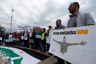 People demonstrate against the Syrian regime ahead of the start of the Syrian Peace talks outside the U.N.