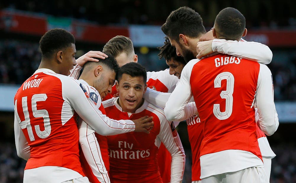 Arsenal's Alexis Sanchez, centre, celebrates scoring a goal during the English FA Cup, fourth round soccer match between Arsenal and Burnley at Emirates stadium in London, Saturday, Jan. 30, 2016. (AP Photo/Kirsty Wigglesworth)