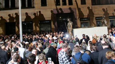  Hundreds of people move past the Cenotaph at Martin Place as a projection of a soldier and a cross is cast displayed on a wall during a Dawn Service on ANZAC Day in Sydney, Australia, Saturday, April 25, 2015. The ANZAC Day memorial Saturday marks the 100th anniversary of the 1915 Gallipoli landings, the first major military action fought by the Australian and New Zealand Army Corps during World War I. (AP Photo/Rob Griffith)
