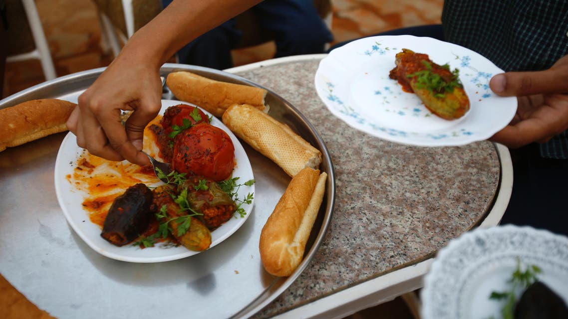 Omer Eltigani, a young British Sudanese pharmacist, serves Sudanese "Mahshi" (stuffed vegetables) that he prepared on January 11, 2016 at his aunt's house in Khartoum.