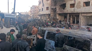 Residents and soldiers loyal to Syria's President Bashar al-Assad inspect damage after a suicide attack in Sayeda Zeinab, a district of southern Damascus, Syria January 31, 2016. At least 60 people were killed, including 25 Shi'ite fighters, and dozens wounded on Sunday by a car bomb and two suicide bombers in the district of Damascus where Syria's holiest Shi'ite shrine is located, a monitor said. Sunni fundamentalist Islamic State claimed responsibility for the attacks, according to Amaq, a news agency that supports the group. REUTERS/Stringer EDITORIAL USE ONLY. NO RESALES. NO ARCHIVE.