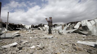 A man records damage at a tea factory after it was hit by Saudi-led air strikes in Yemen's capital Sanaa. (Reuters)