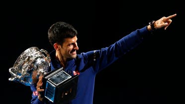 Novak Djokovic of Serbia waves as he walks around Rod Laver Arena after defeating Andy Murray of Britain in the men's singles final at the Australian Open tennis championships in Melbourne, Australia, Sunday, Jan. 31, 2016.