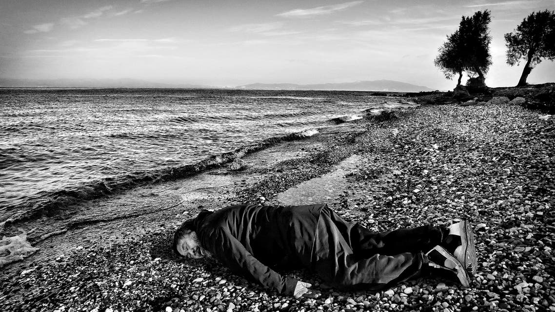 This Jan. 25, 2016, image provided by the India Today news magazine shows Chinese artist and activist Ai Weiwei posing as he lies face down on the beach on the Greek island of Lesbos. Chinese artist Ai Weiwei has recreated the famous image of a 3-year-old Syrian child who drowned in Turkey last year by staging a photo of himself lying face down on a beach in Greece. The photograph last year of the child lying on a Turkish beach triggered international outrage as people saw the helpless toddler as the devastating human face of the refugee crisis in Europe. (Rohit Chawla/India Today via AP) NO ARCHIVE, NO LICENSING, MANDATORY CREDIT