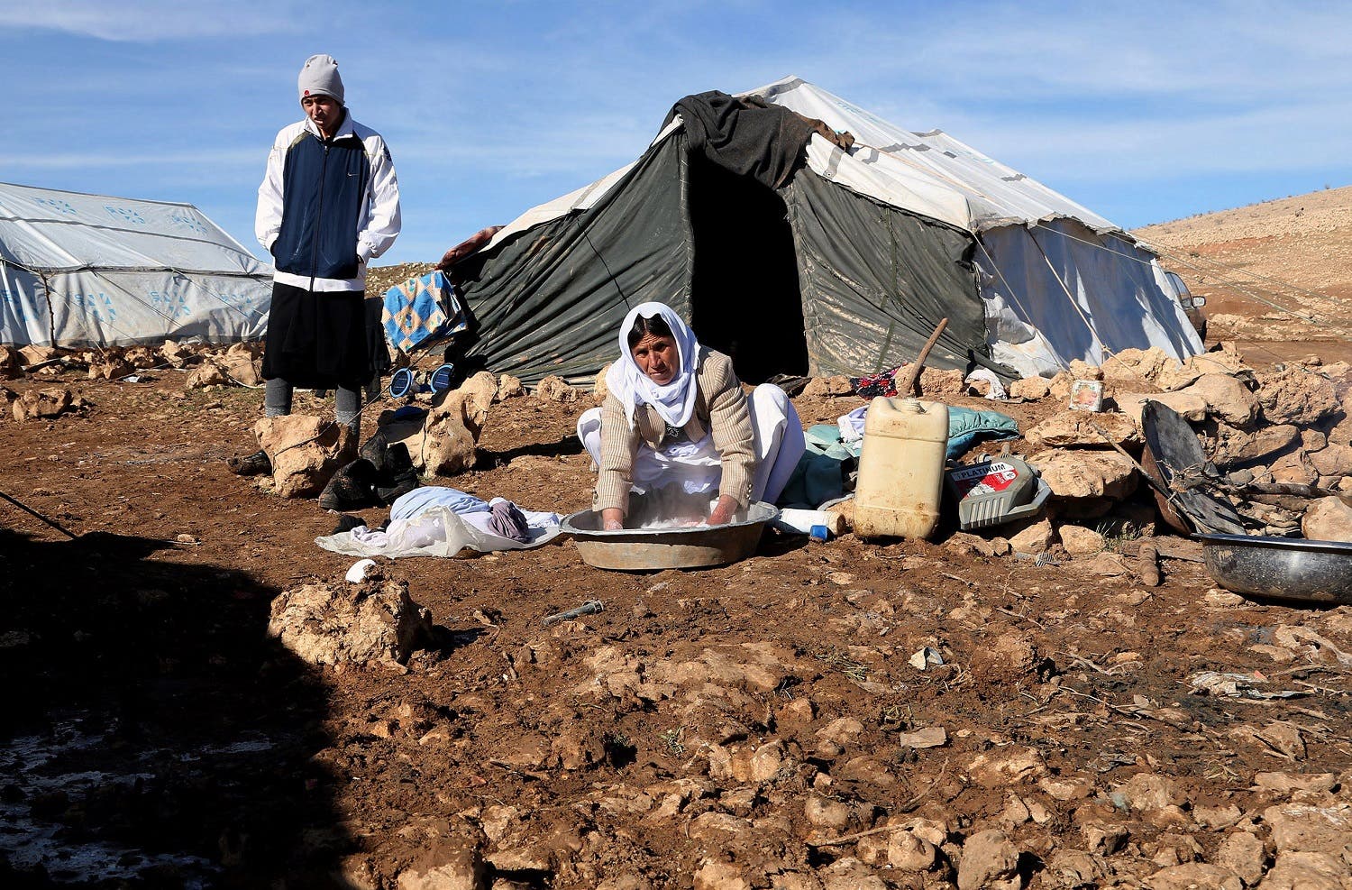Iraqis from the Yazidi minority gather outside their makeshift homes on Mount Sinjar in northern Iraq. (AP)