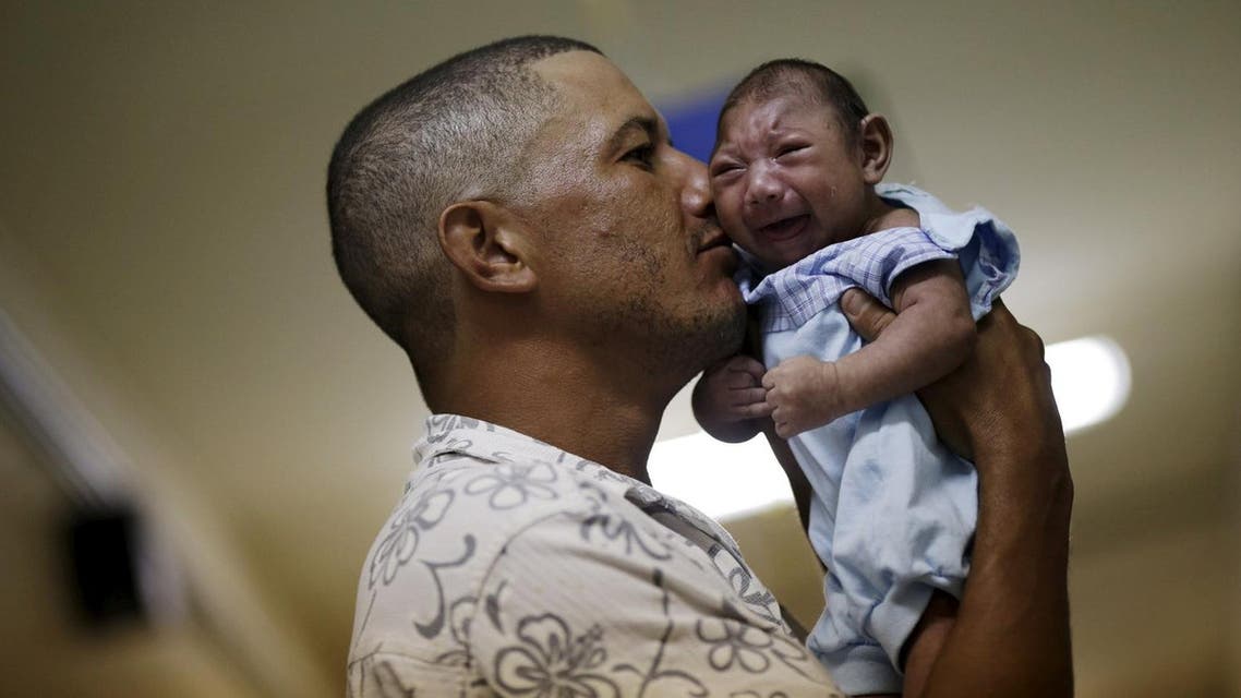 Geovane Silva holds his son Gustavo Henrique, who has microcephaly, at the Oswaldo Cruz Hospital in Recife, Brazil. (Reuters)