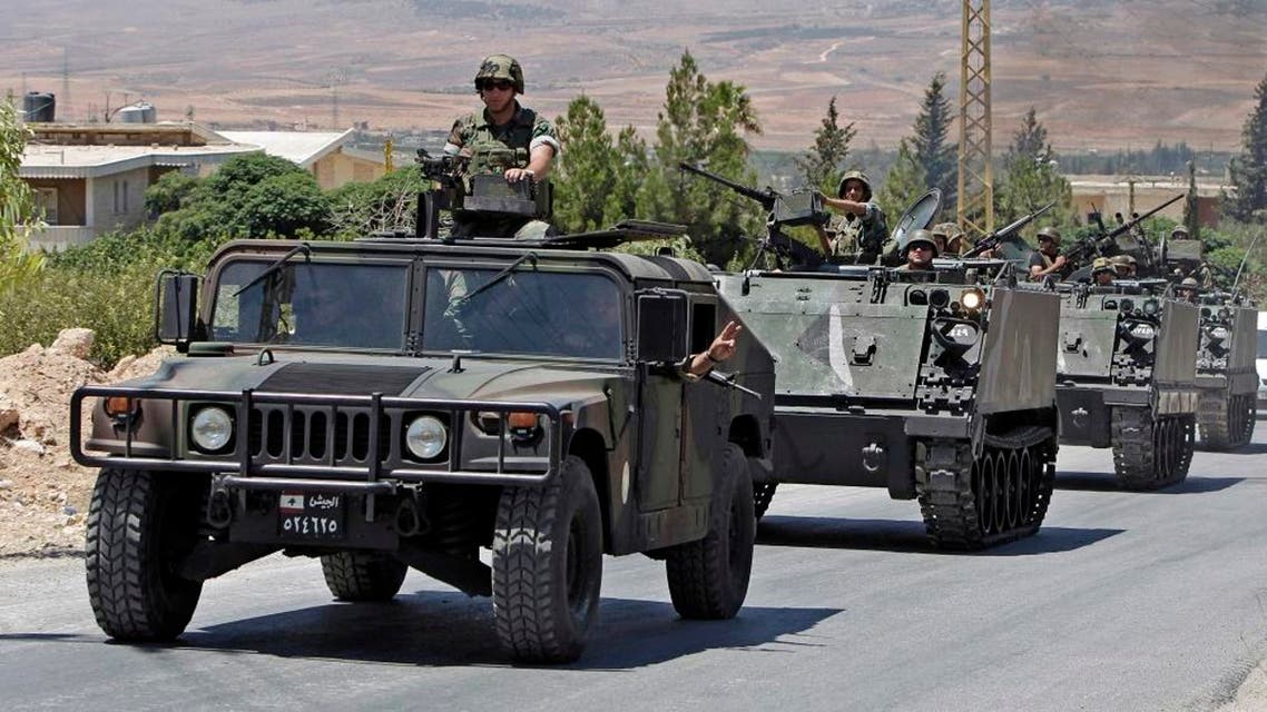 In this Aug. 4, 2014, file photo, Lebanese army reinforcements arrive at an area on the outskirts of Arsal, a predominantly Sunni Muslim town near the Syrian border in eastern Lebanon. A roadside bomb exploded near an army patrol in Arsal, wounding at least three soldiers, the military said Friday, Nov. 14. (AP Photo/Bilal Hussein, File)