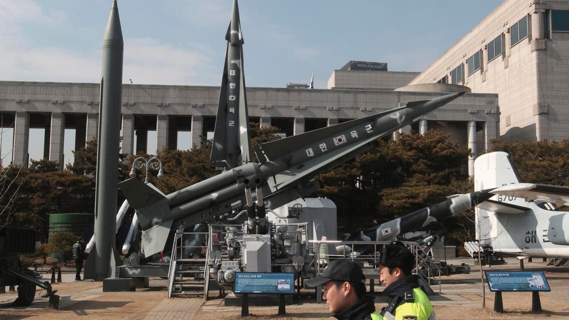 Police officers walk by a mock Scud-B missile of North Korea, left, and other South Korean missiles on display at the Korea War Memorial Museum in Seoul, South Korea, Wednesday, Feb. 3, 2016. South Korea warned on Wednesday of "searing" consequences if North Korea doesn't abandon plans to launch a long-range rocket that critics call a banned test of ballistic missile technology. (AP Photo/Ahn Young-joon)
