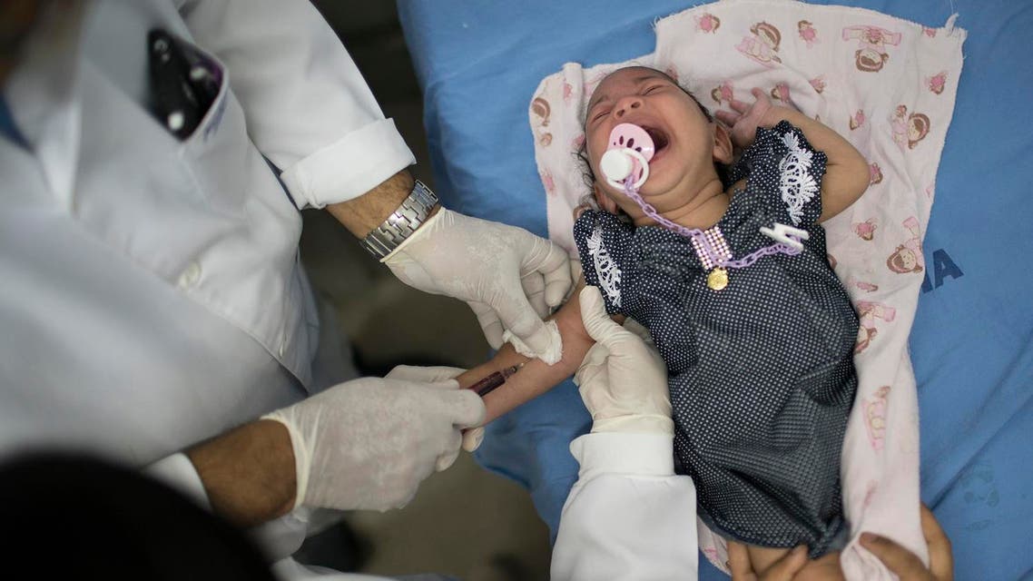 A doctor draw blood from Luana, who was born with microcephaly, at the Oswaldo Cruz Hospital in Recife, Brazil, Thursday, Jan. 28, 2016. ap