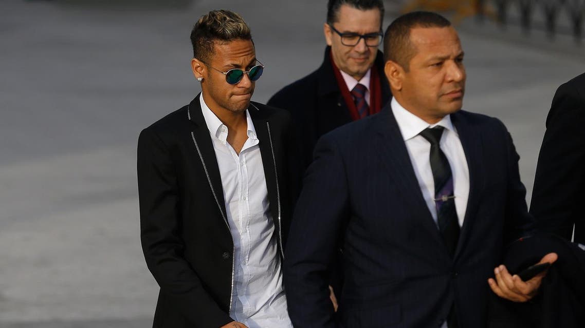 FC Barcelona's Neymar arrives with his father Neymar Santos, right, to the national court to testify in an investigation into alleged irregularities regarding his transfer to Barcelona, in Madrid, Tuesday, Feb. 2, 2016. (AP)