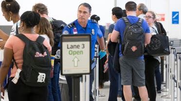 A Transportation Security Administration agent, center, helps passengers navigate through the lines as they pass through security at the Fort Lauderdale-Hollywood International Airport. (File photo: AP)