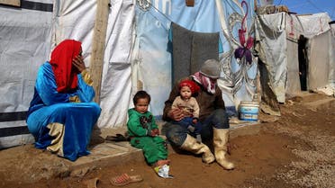 A Syrian family sit outside their tent, at a Syrian refugee camp, in the eastern town of Kab Elias, Lebanon. (File photo: AP)