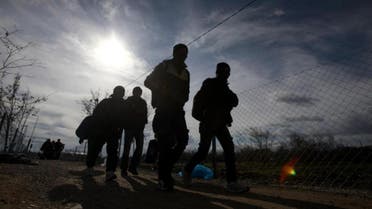 Refugees walk towards the border with Serbia from the transit center for refugees near northern Macedonian village of Tabanovce, Friday, Feb. 5, 2016. Macedonia accepts people only from war-affected zones who declare Austria or Germany as their final destination (AP)