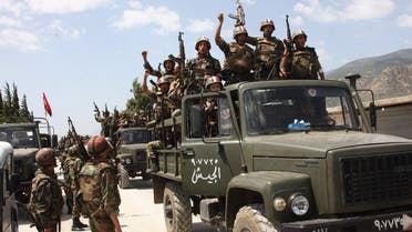 In this June 10, 2011, file photo, taken during a government-organised visit for media, Syrian army soldiers standing on their military trucks shout slogans in support of Syrian President Bashar Assad. AP