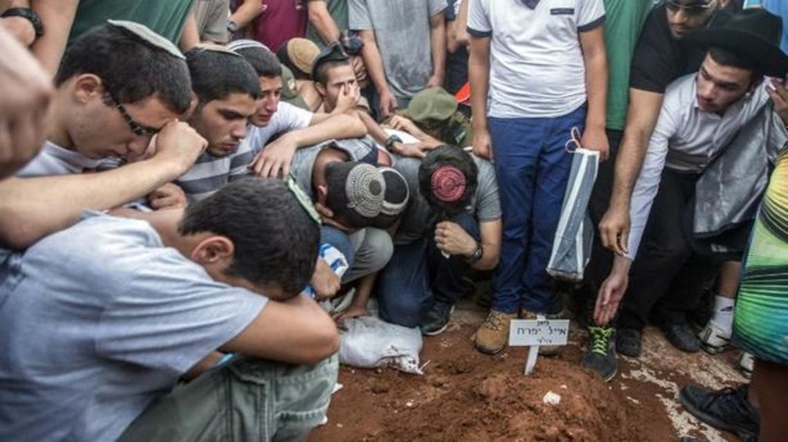 Relatives and friends at the burial of the teenagers for whom the burnt synagogue was dedicated (AFP) - See more at: http://www.middleeasteye.net/news/tent-served-synagogue-burned-west-bank-684035800#sthash.tErxDX08.dpuf