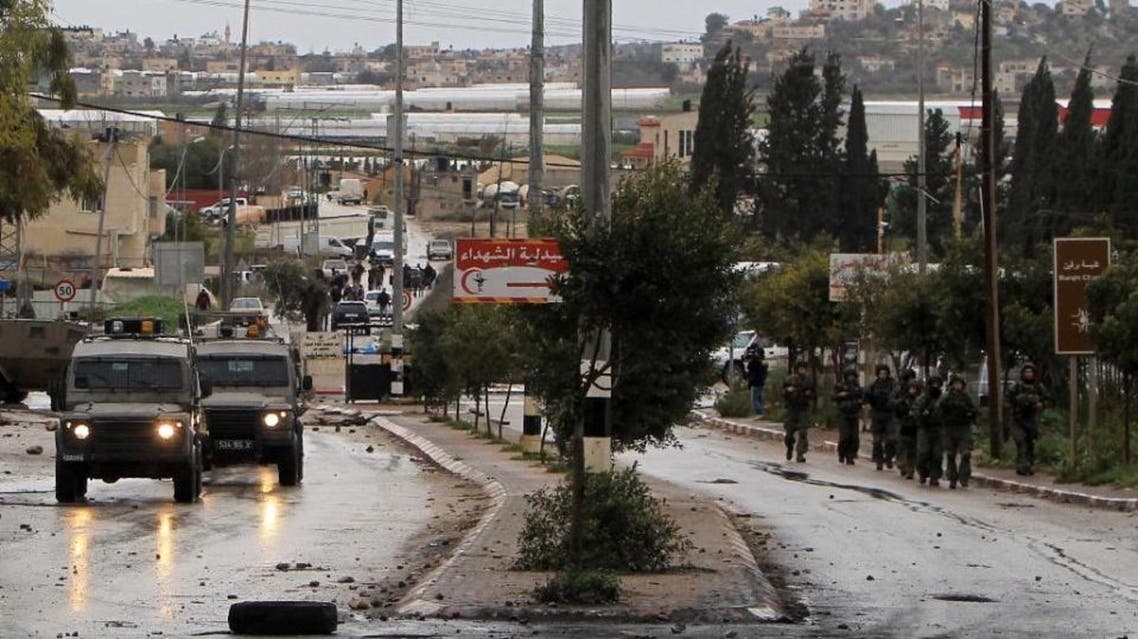 Israeli security forces advance in the village of Qabatiya, near the West Bank town of Jenin, during clashes with Palestinian protestors on February 6, 2016 (AFP)
